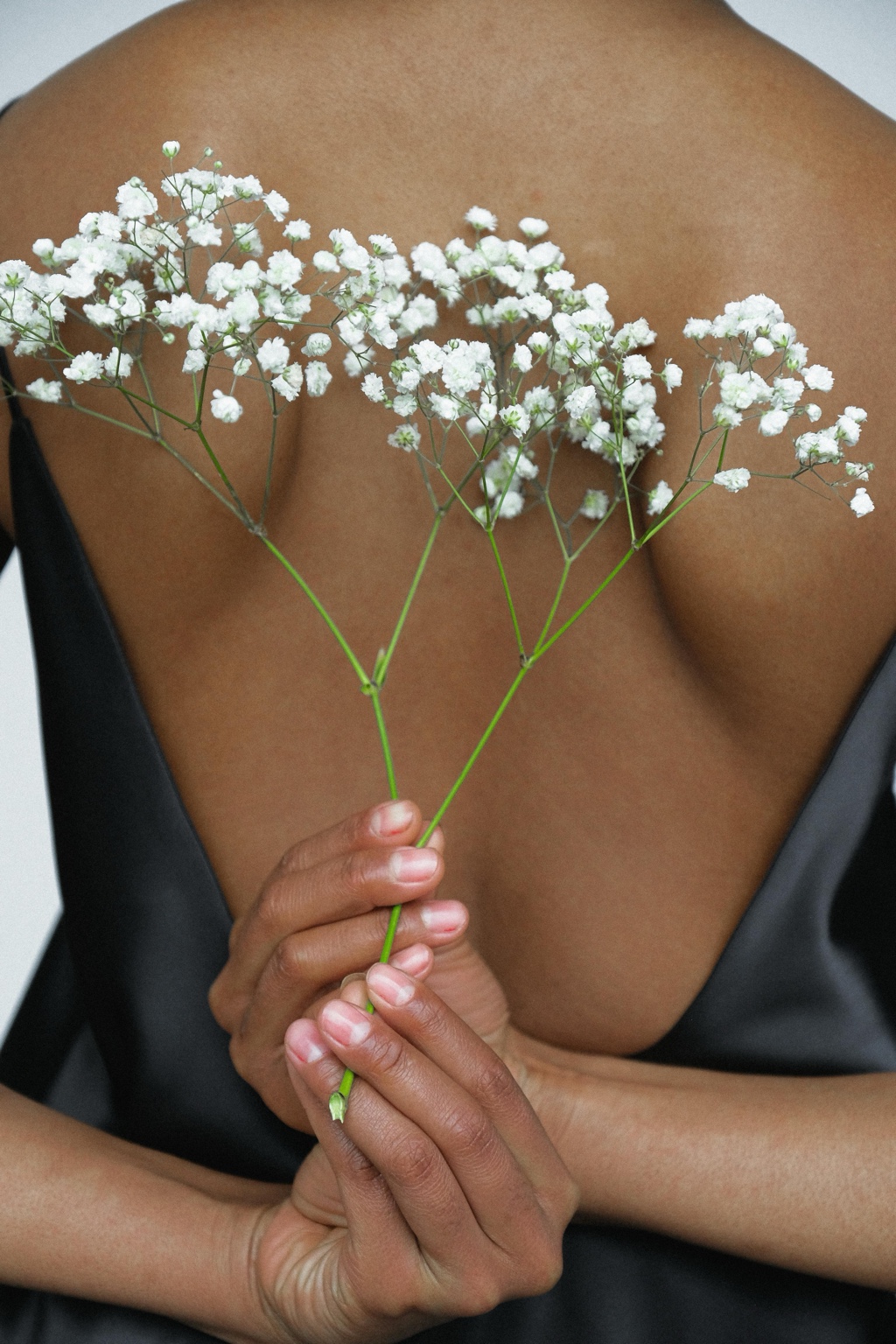 Hands holding white flowers